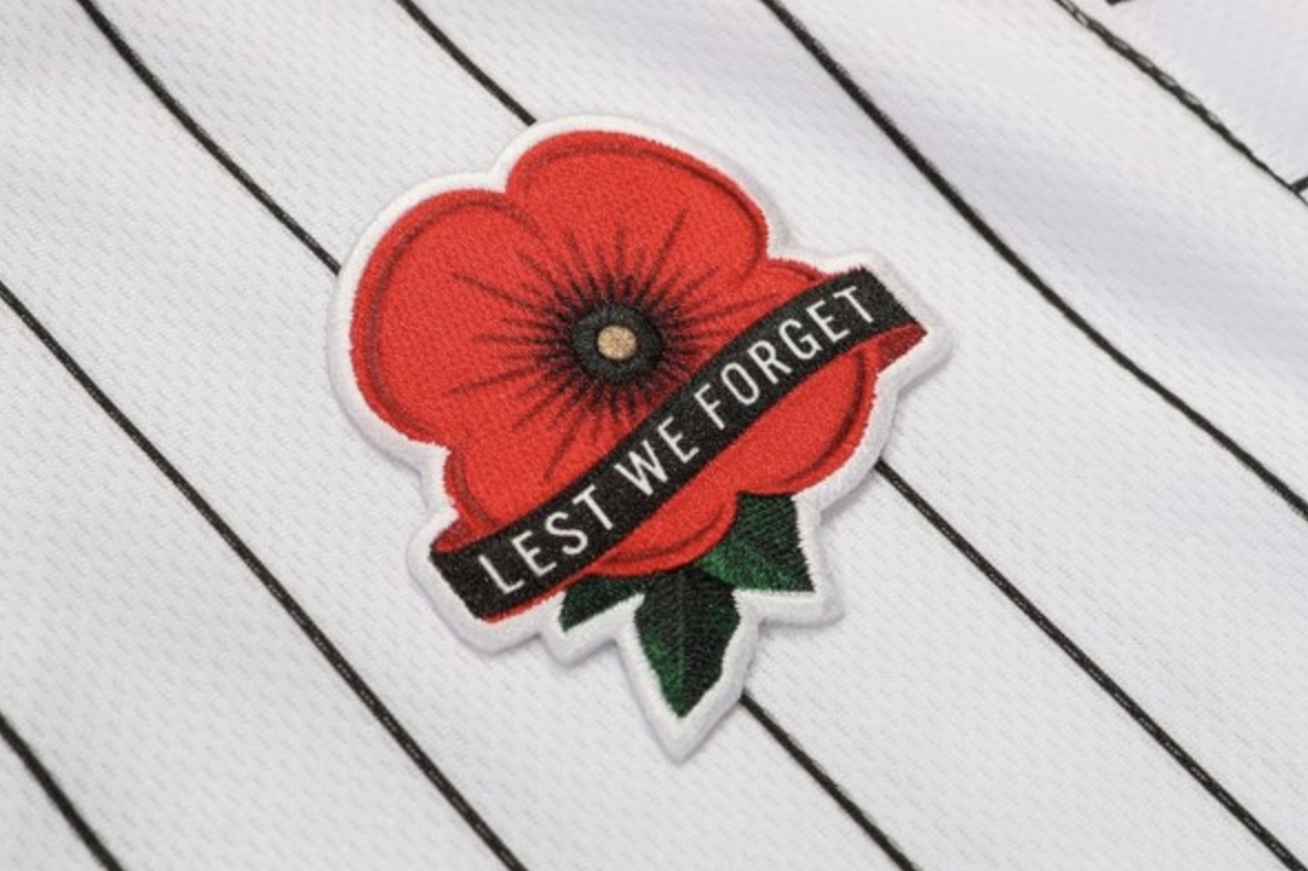 Why is the MLB wearing red poppies on jerseys today? All 30 teams don  patches with the words Lest We Forget